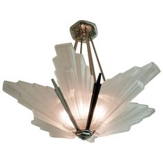 an art deco chandelier with glass petals and metal rods, designed by person