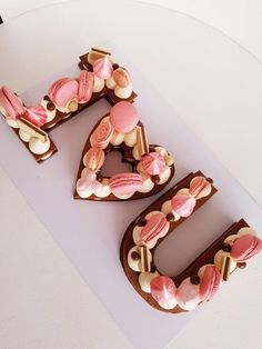 a cake shaped like the number 50 with pink and white frosting on it's sides