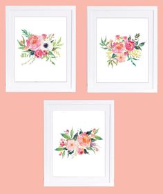 three watercolor flowers are hanging on the wall in front of two framed pictures with pink walls