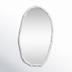 an oval shaped mirror is shown against a white background with the reflection of it's curved edge