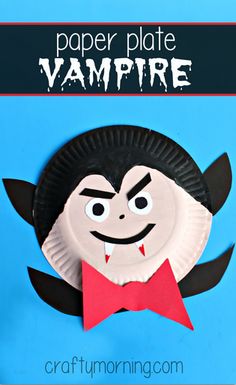 a paper plate with a dracula face and red bow tie on it's side