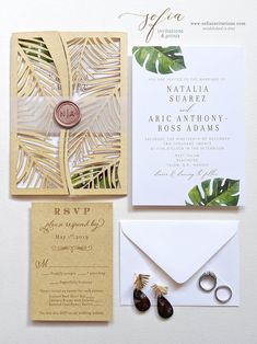 an image of wedding stationery with tropical leaves on the front and back, including a ring