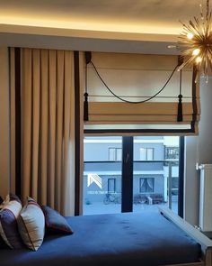 a bedroom with a large bed and a chandelier hanging from the ceiling