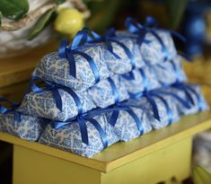 four blue and white wrapped presents on a table