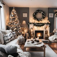 a living room decorated for christmas with candles and wreaths on the fireplace mantel