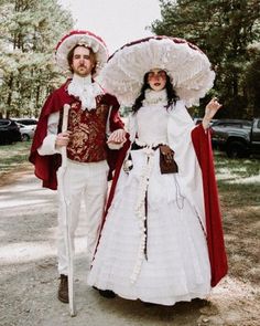 two people dressed in period costumes standing next to each other