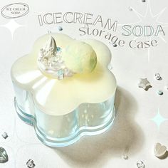 an ice cream soda storage case sitting on top of a white surface with stars around it