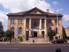 an old brick building with columns on the front