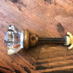 an old wooden table with a glass door handle