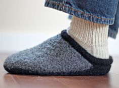 the feet of a person wearing slippers and socks