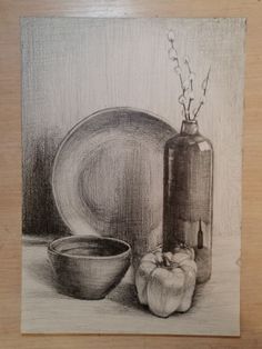 a drawing of a bowl and plate next to a vase with flowers in it on a wooden surface