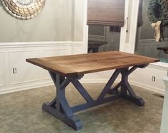 a wooden table sitting in the middle of a room