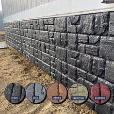 the side of a building with several different colors of bricks and gravel on each wall