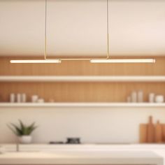 a kitchen with white counter tops and wooden shelves on the wall, along with modern lighting fixtures