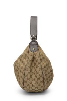 This Gucci hobo bag features the signature GG monogram canvas. It has a top handle and a zip closure with a signature Gucci charm. The bag is made of canvas with leather trim. Gucci Hobo Bag, Gg Monogram, A Signature, Leather Trim, Hobo Bag, Monogram Canvas, Leather Trims, Top Handle, Monogram