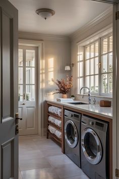 a washer and dryer in a very nice looking room with lots of windows