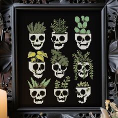 a cross stitch pattern with skulls and succulents in the shape of plants