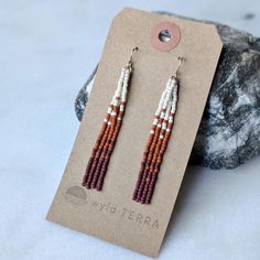 A neutral warm color fade that you will love wearing all year long! These fringe earrings are the same look you love in a shorter style. Perfect for those days when you are more active, out exploring nature! A beautiful & neutral warm color fade inspired by that magical time of year when we are transitional from summer to fall. The days still have a touch of warmth to them, while the colors begin to change.  These earrings are very lightweight. A more playful, free flowing option to studs. Featuring 4 strands of hand woven matte glass beads. These unique matte glass beads have a very luxe look and feel to them.  Colors: These beaded earrings feature an ombre fade of matte ivory, terra cotta and oxblood glass beads.  Length: Approximately 3" drop length Metal Options: 14K Gold Fill or Sterl Beaded Fringe Earrings, Exploring Nature, Earrings Fall, Gold Alloys, Ear Candy, Free Flowing, Wedding Jewelry Earrings, Beaded Fringe, Warm Autumn