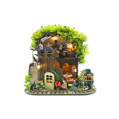 a toy house with lots of trees and plants on the roof is shown in front of a white background