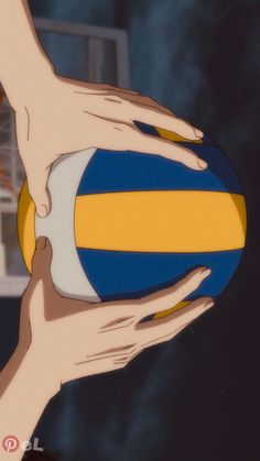 two hands holding a blue and yellow ball