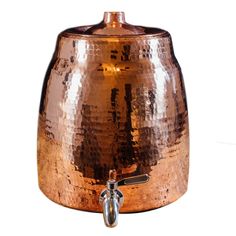 a large copper colored pot with a handle