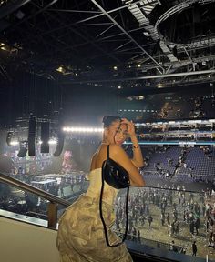 a woman standing in front of a crowd at a stadium