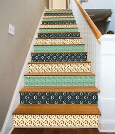 the stairs are decorated with colorful wallpapers and decorative stair treading strips, as well as an area rug