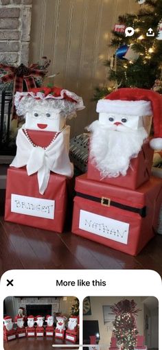 two santa clause boxes sitting next to each other in front of a christmas tree