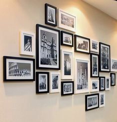 a wall with many black and white pictures on it