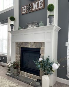 a living room with gray walls and white fireplace