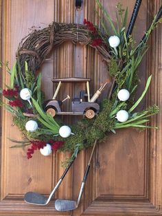 a wreath is hanging on the front door with golf balls, clubs and an old car