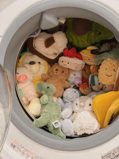 there are many stuffed animals in the washing machine