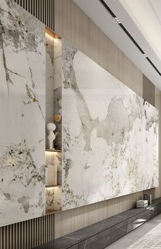 a large white marble wall in a lobby