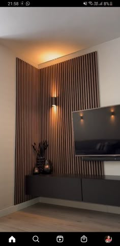 a flat screen tv mounted to the side of a wall next to a wooden paneled wall