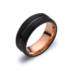 a black and rose gold wedding ring on a white background