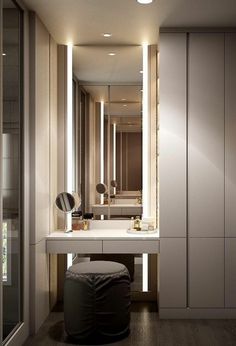 a bathroom with a vanity, stool and large mirror in the wall next to it