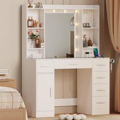 a white vanity with lights on it in a bedroom