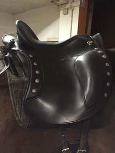 a close up of a black saddle on a horse