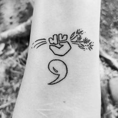 a small tattoo on the wrist of a person with a plant in it's hand