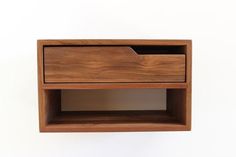 a wooden shelf with two drawers on it's sides and one drawer open in the middle