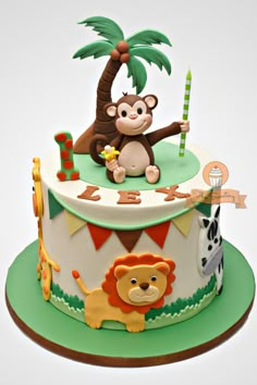 a birthday cake with a monkey and giraffe on it