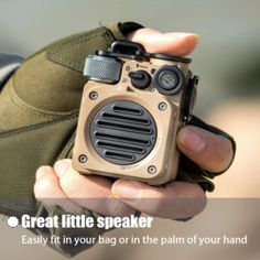 a person holding a small camera in their hand with the caption great little speaker easily fit in your bag or in the palm of your hand