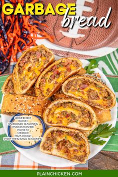 a plate filled with meat and cheese on top of a table next to a football ball