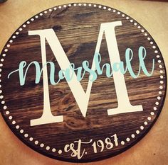 a wooden sign with the letter m on it