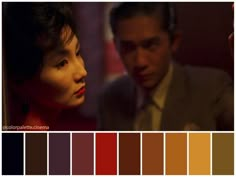 a man and woman standing next to each other in front of a red wall with color swatches