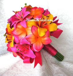 a bridal bouquet with pink, yellow and orange flowers on a white lace background