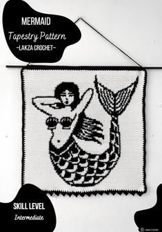 the mermaid tapestry pattern is hanging on a wall with black and white text above it