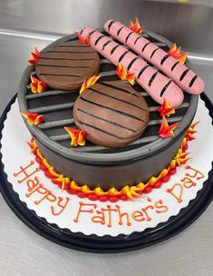 a birthday cake with hot dogs and hamburgers on the grill for father's day