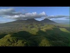 an aerial view of some hills and clouds