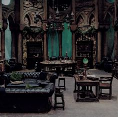 a living room filled with lots of furniture and walls covered in intricate carvings, including an ornate fireplace